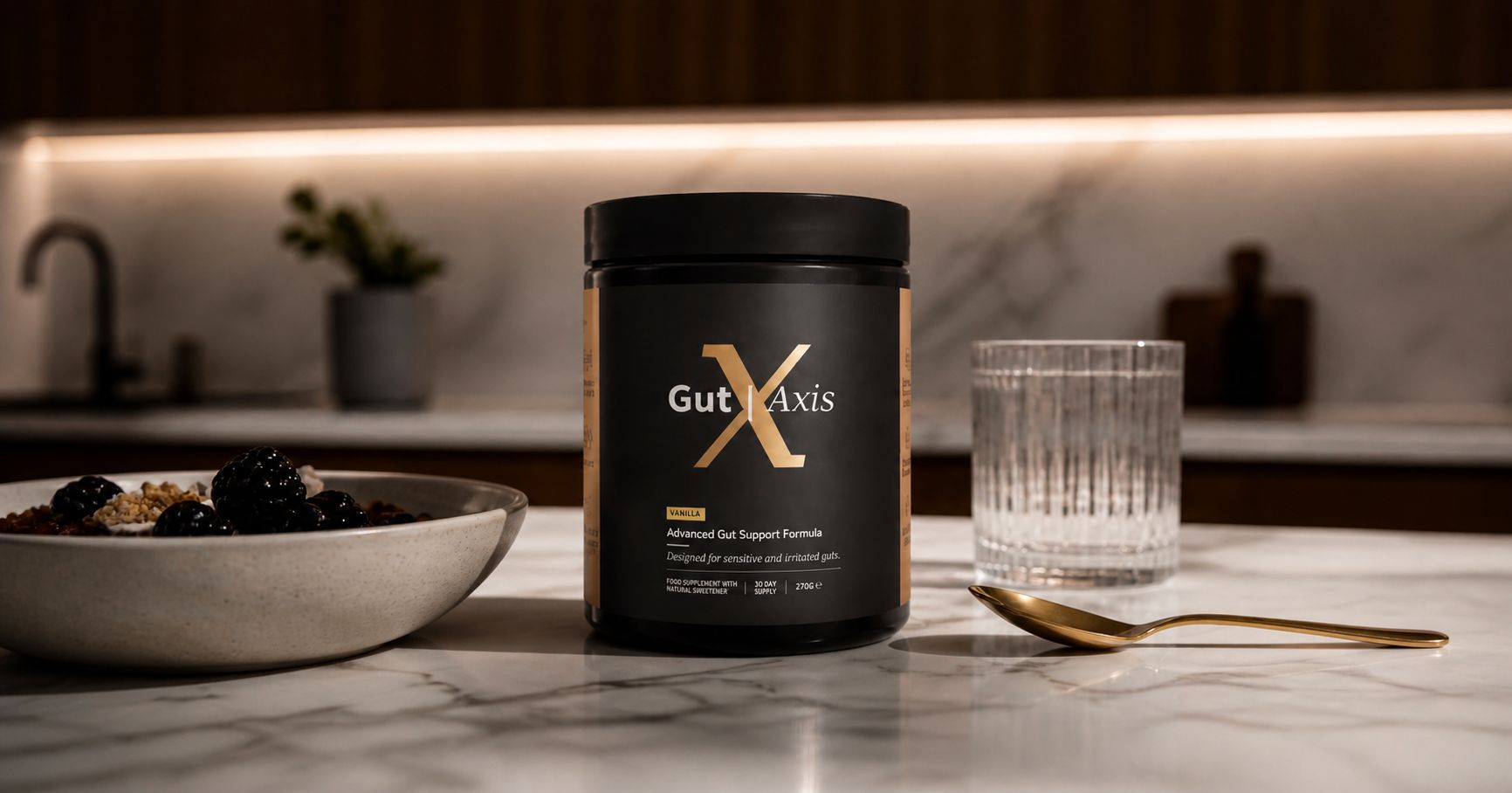 Gut Axis supplement container on a kitchen counter with a bowl of berries and a glass.